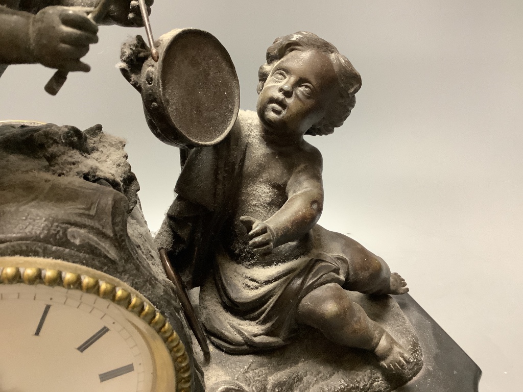 An early 20th century French spelter and slate cherub mantel clock, height 34cm